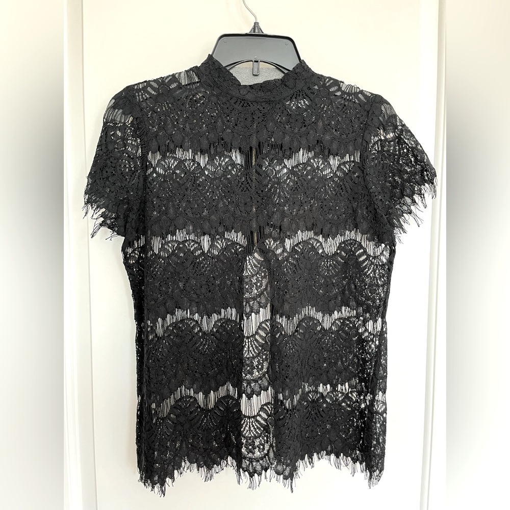 Never Worn brand new. Black lace style top. Very gorgeous.